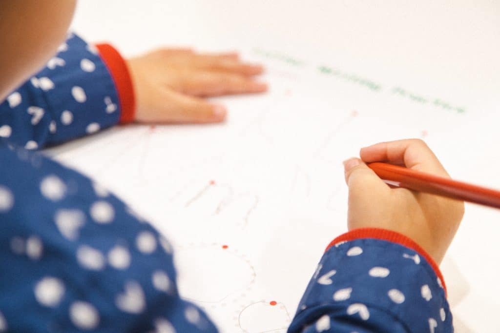 Transitioning To Kinder - young child practicing writing in a Shichida class
