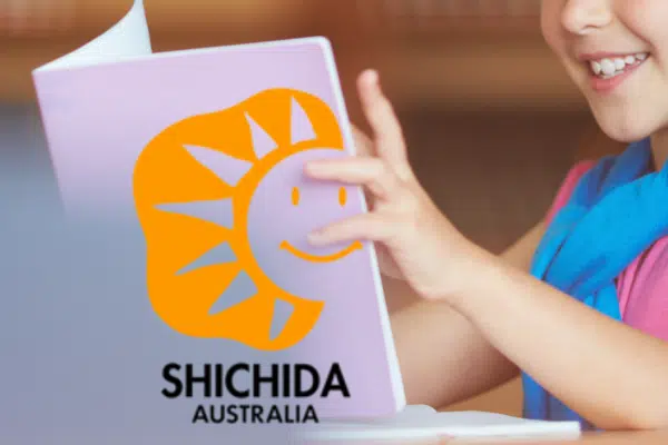 A picture for an article about a Shichida Baby that can read showing a young child holding up a book