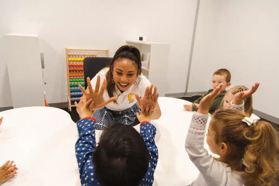 Early Learning Program Instructor giving kids high five's in a Shichida class