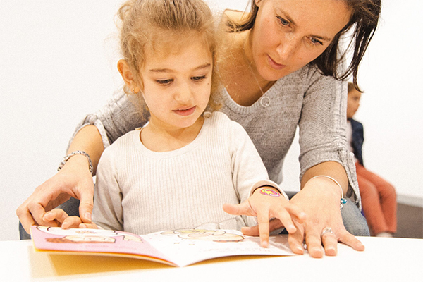 parent reading with preschool child in a Shichida class