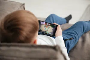 Impact of technology on children's memory - A young child playing on a mobile phone