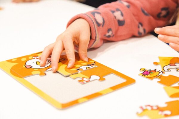 FAQ page image of a child building a puzzle