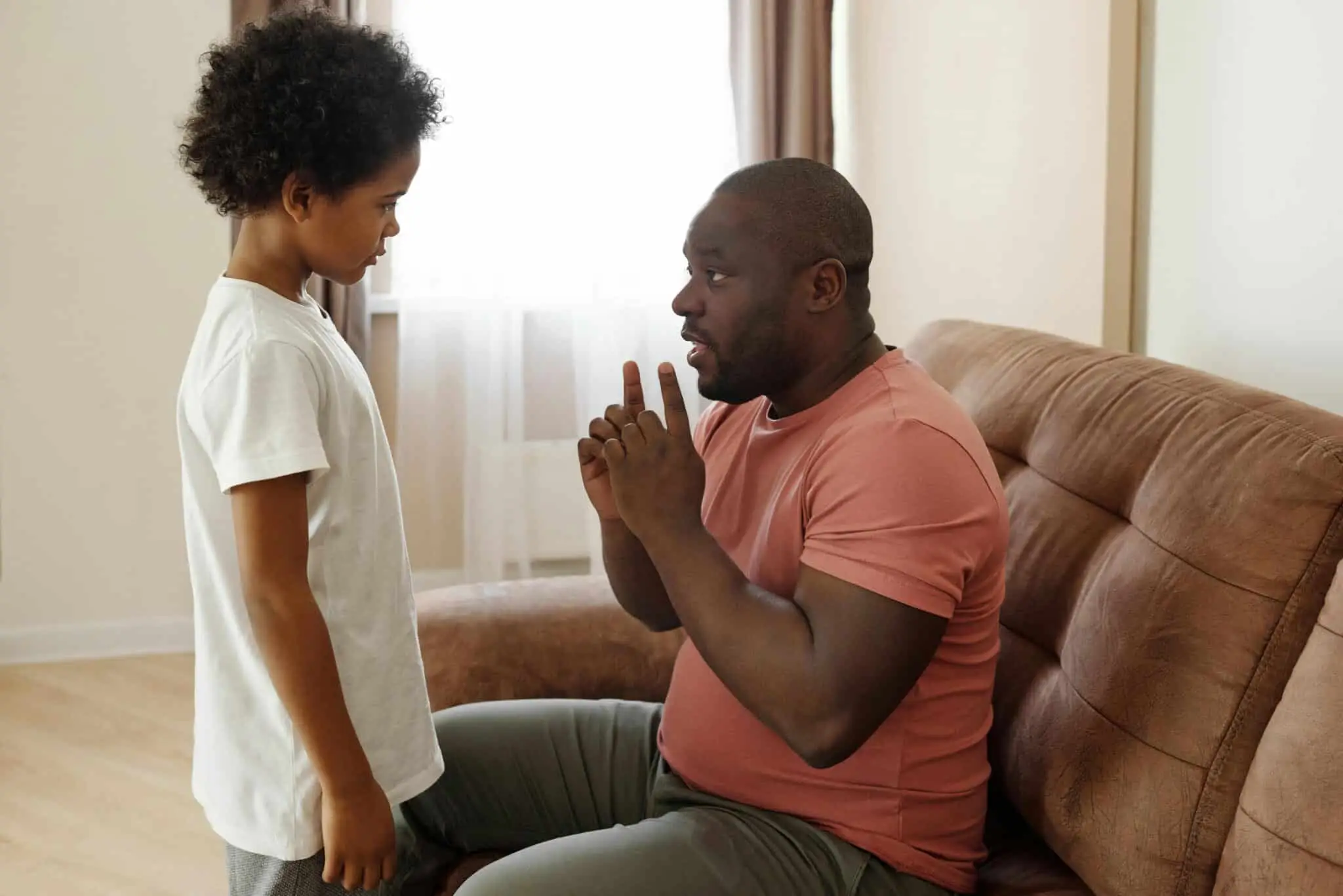 A father explaining something to his son, explaining reasons for saying no is important