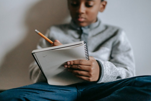 Feelings Journal, boy writing in notebook