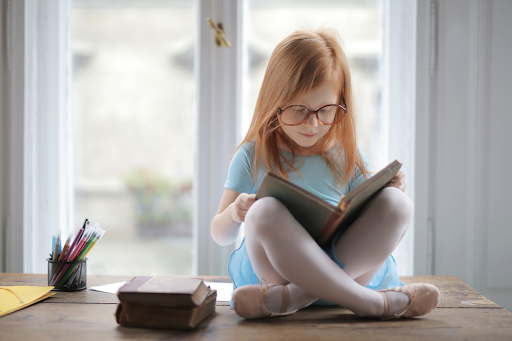 Speed reading benefits- a young girl reading a book