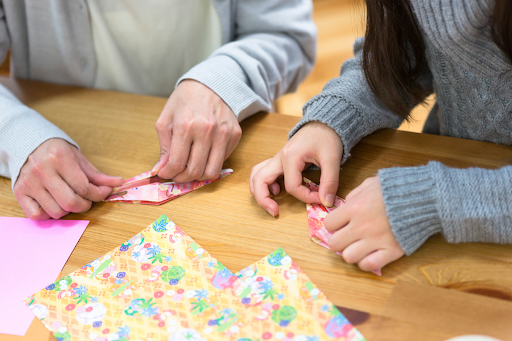 Two people folding origami