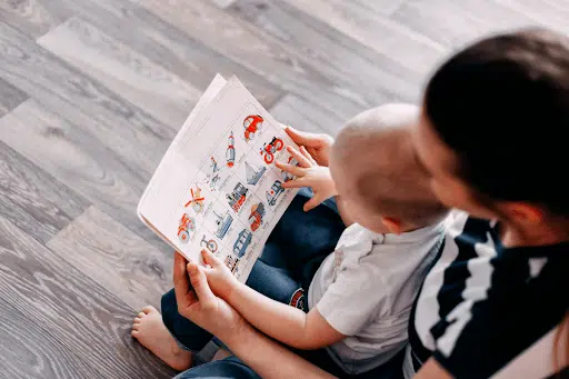Mum and child looking through a picture book