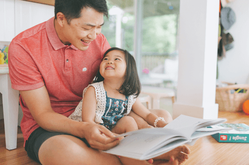 Dad reading with young daughter