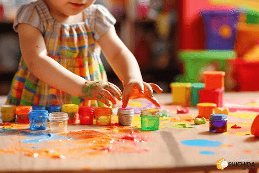Allowing them to learn and grow, a little girl playing with paint