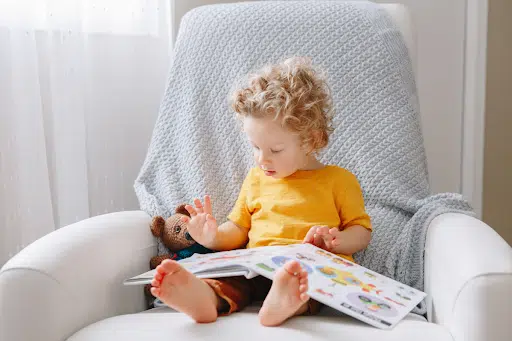 Fostering a love for learning, young child looking through a picture book
