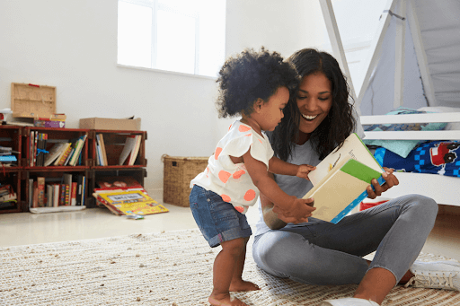 Nurturing learning, mum and young child looking through a book together