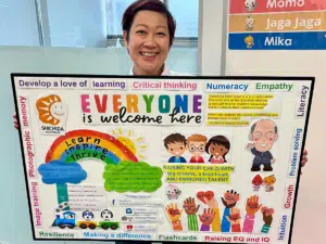 Friendly instructor with parent information board