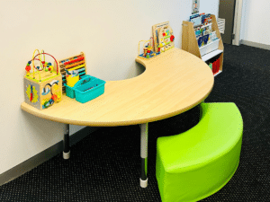 Waiting area, featuring books, a drawing table and educational toys