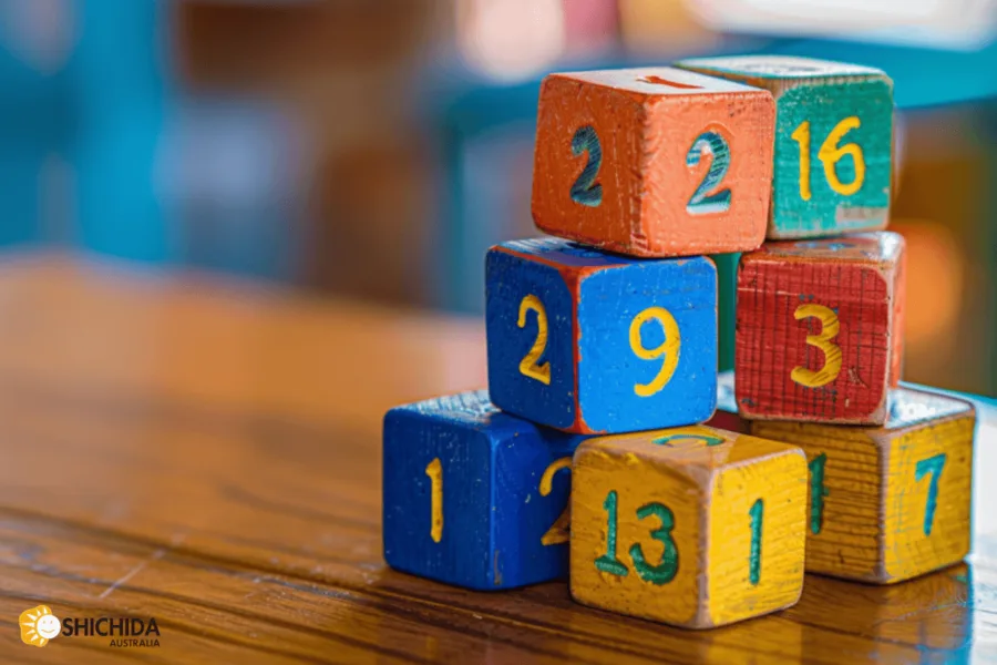 Building strong number sense in kids during early learning. Blocks showing numbers on their faces stacked in a pile.