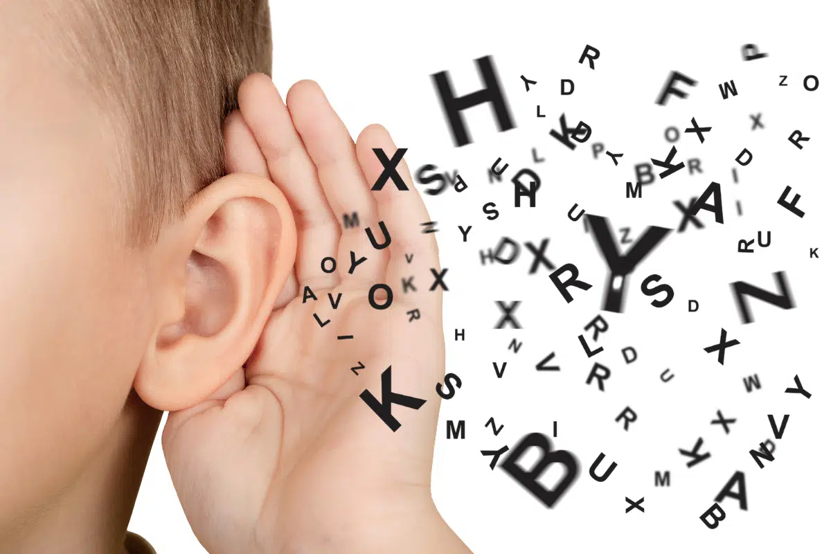 A child cupping his ear with alphabet letter graphics seemingly coming from his ear, demonstrating the concept of teaching kids active listening skills