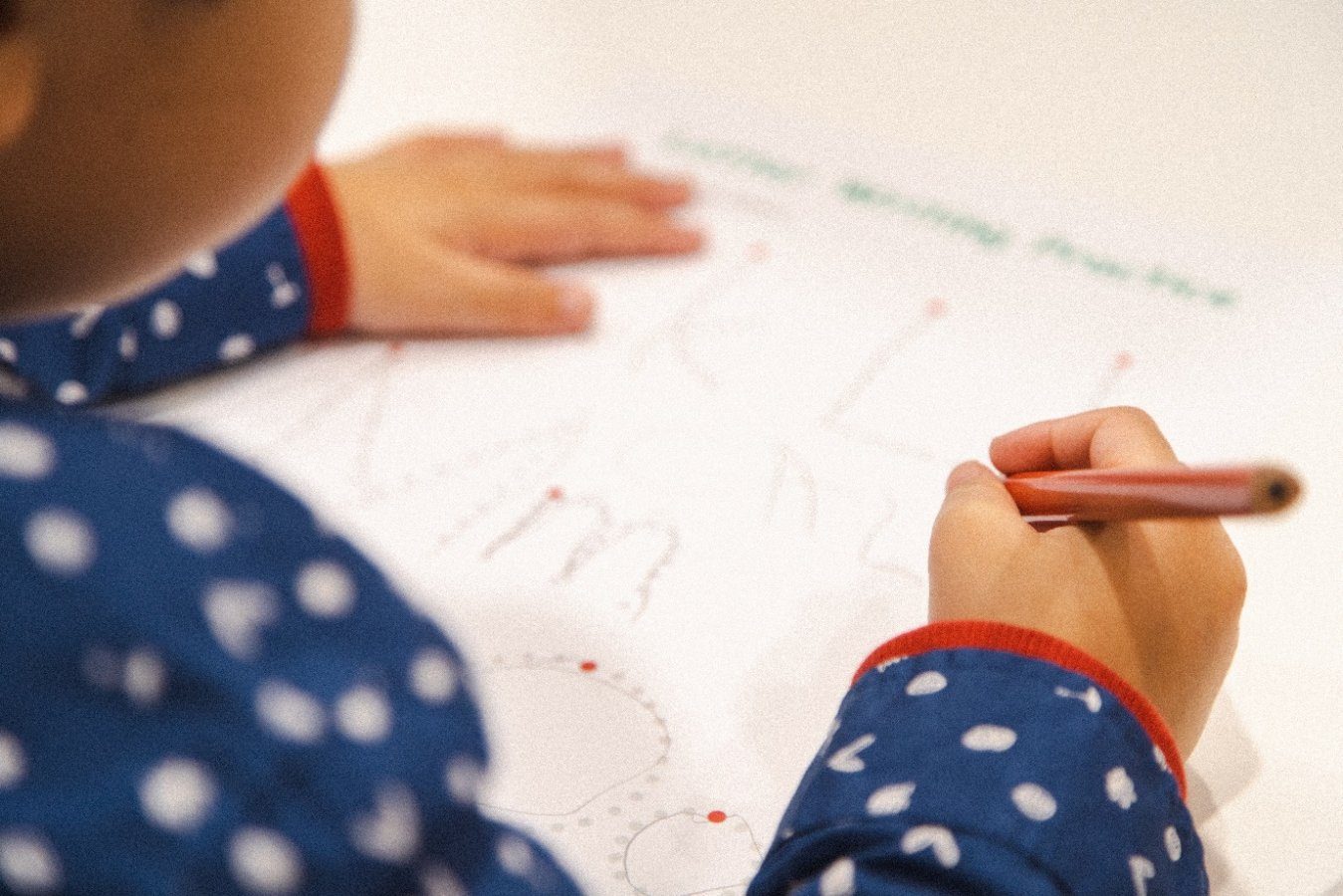 A preschooler writing Alphabet Letters