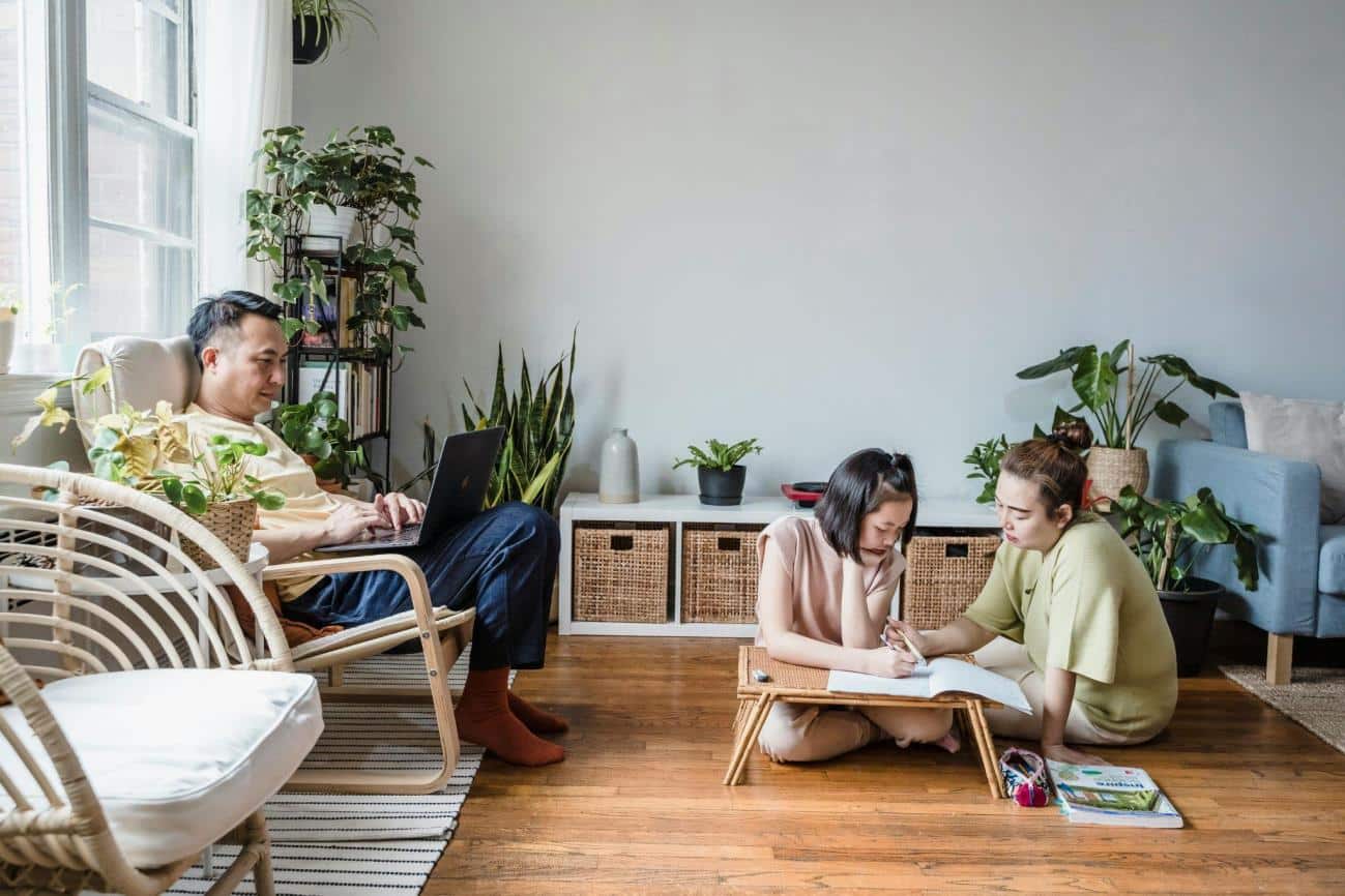 A Woman Helping her Daughter with her Homework while Sitting on the Floor while Harnessing Visualisation Techniques