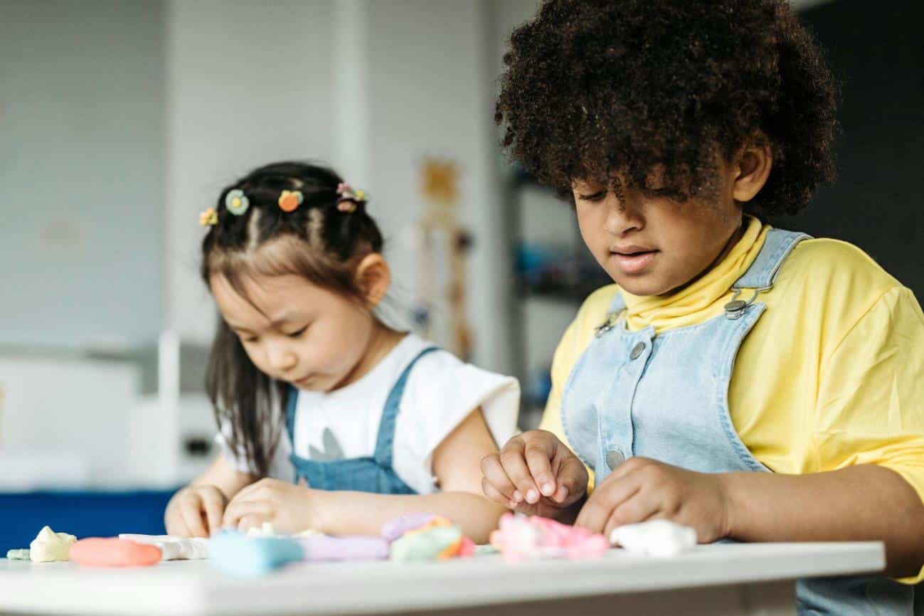 Kids Sitting at a Table doing fine motor skills activities