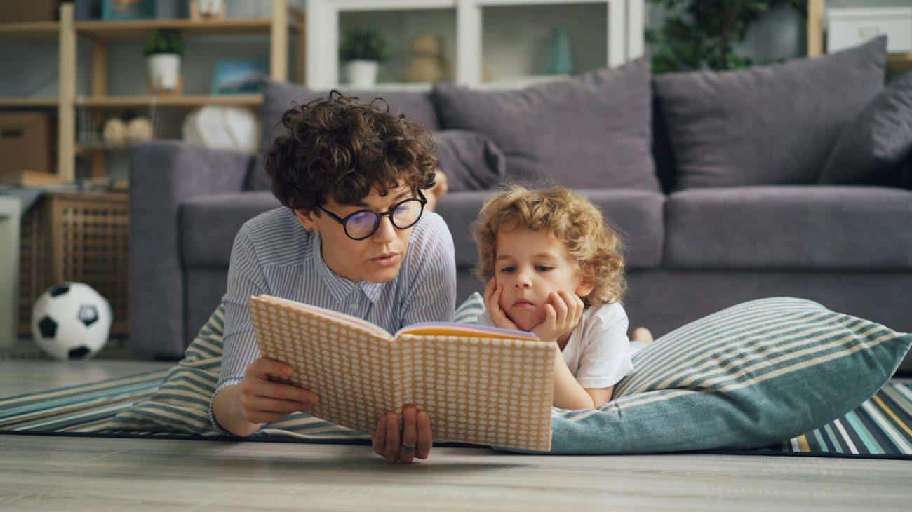 Mother Lying Down with Son and Reading Book