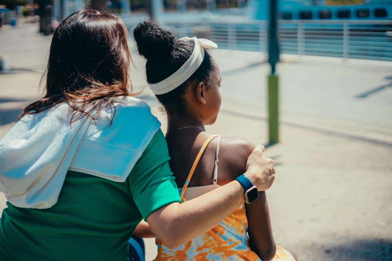 Developing Intuition in Children, How Parents Can Support Natural Growth and Decision-Making Skills, Woman in Green Shirt holding a girl protectively