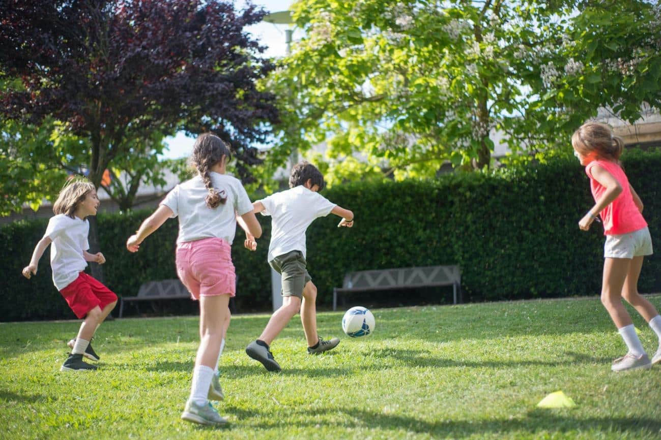 Young Kids Playing Football on the Field, quick decisions are helped by developing intuition