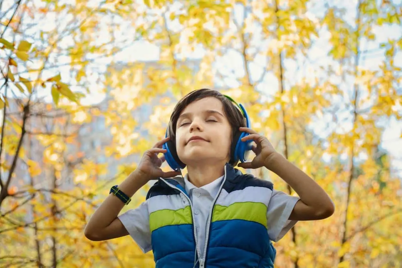 auditory sensory activities, here a boy is Listening and learning under the open sky