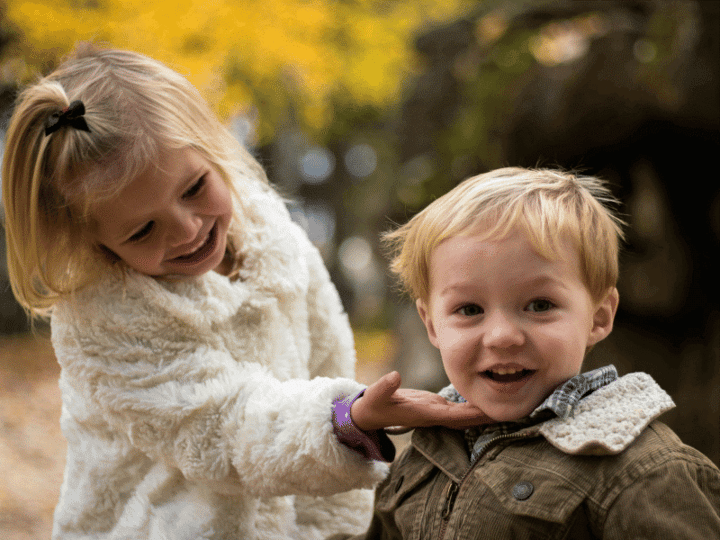 What is Emotional Intelligence? A young girl with blonde hair gently touches a boy's chin, and they are both smiling.