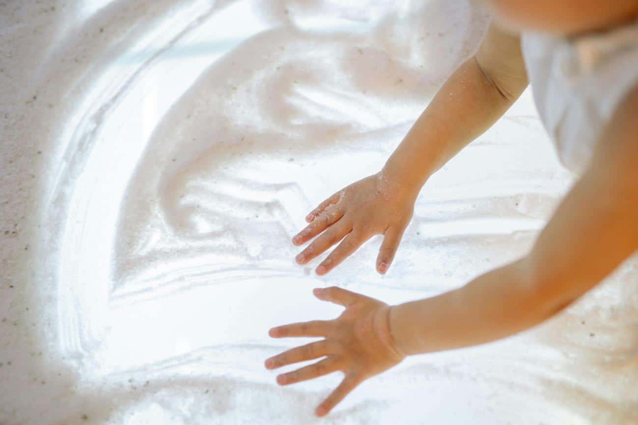 A Child Playing with Salt for sensory play