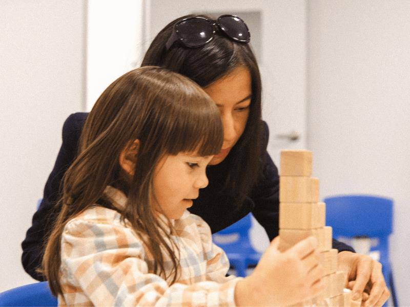 A parent and young child completing an activity together during a Shichida class