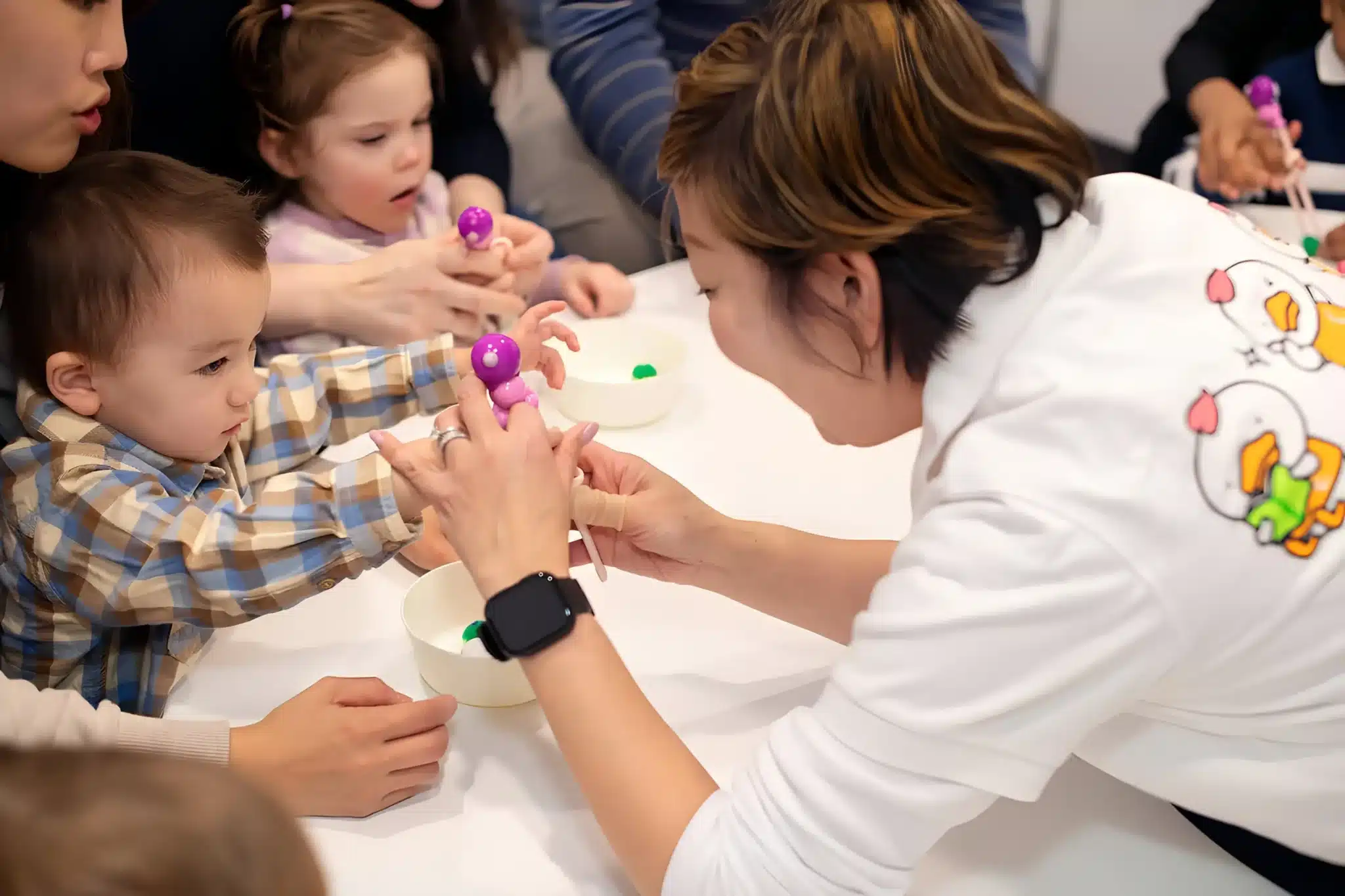 Early childhood education - Toddlers practise using chopsticks to transfer toys