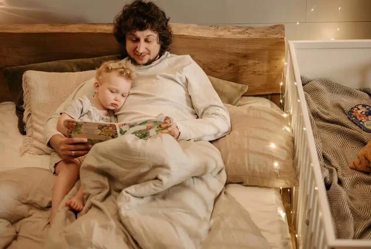 A father reading and singing to his toddler