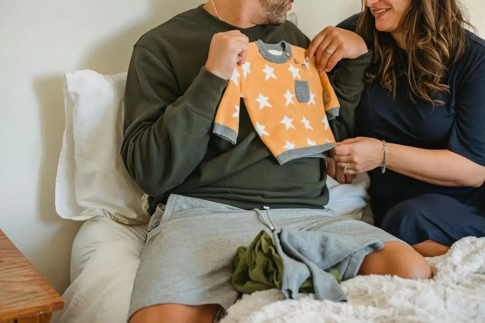 parents preparing the clothes for the baby
