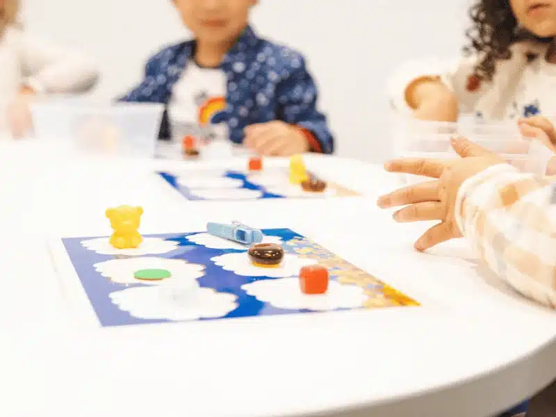 Toddlers playing with colored objects