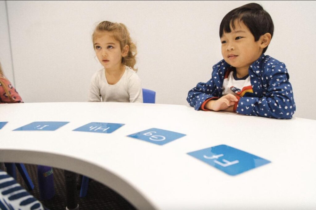 Image by Shichida Australia: A Shichida class with young children exploring letters during a group sound-matching exercise. Confidence building activities for kids help develop focus, collaboration, and a love for learning from an early age.