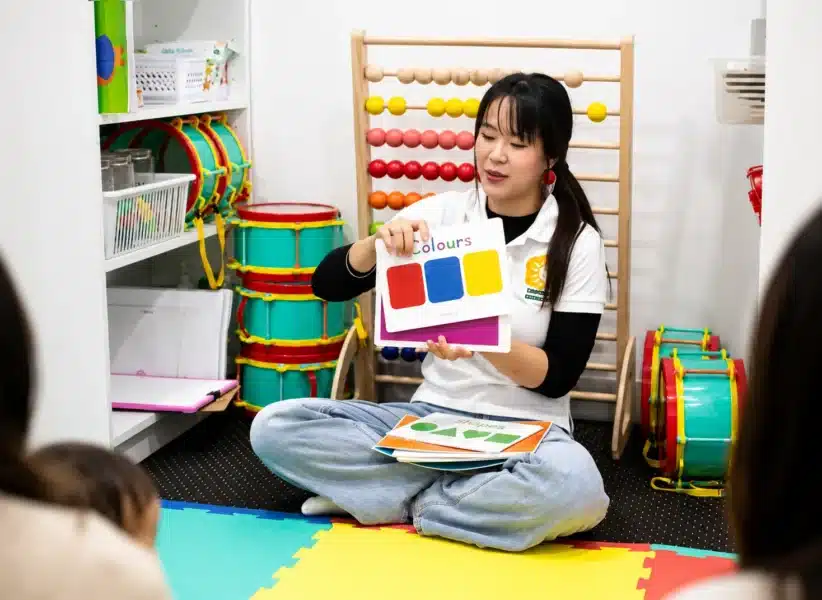 Early childhood educator teaching colours with flashcards - visual tracking activities