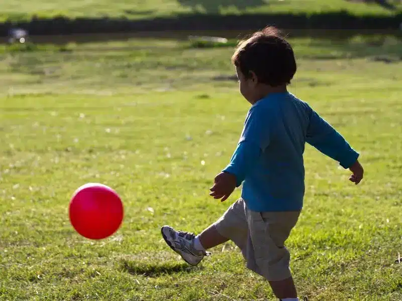 Start with one word, then build from there. “Ball” can become “red ball,” “big ball,” and eventually, “kick the ball.”