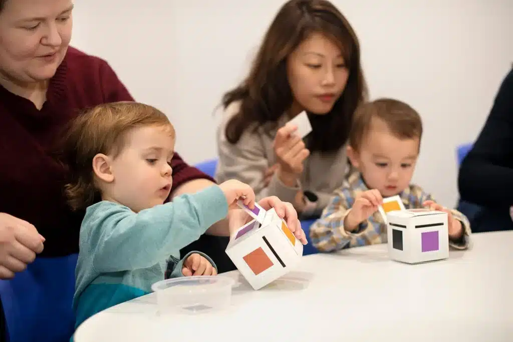 Image by Shichida Australia: As toddlers post each colour card into the matching box, they practise finger control, concentration, and colour learning.