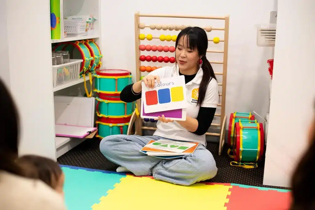 Shichida teacher showing colour flashcards to young children