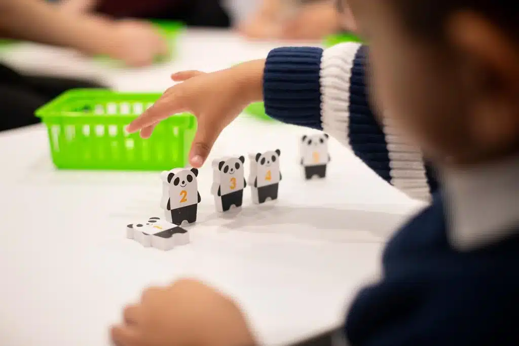 spatial awareness - Preschooler arranging numbered panda blocks in sequence