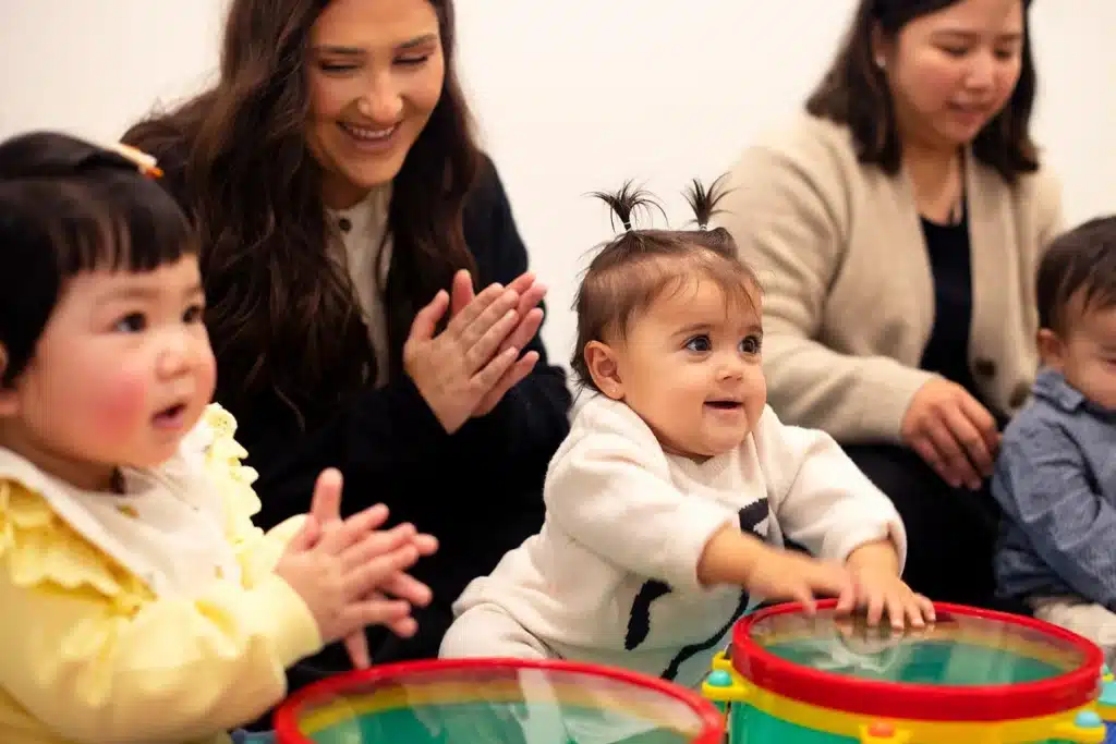 Babies drumming and clapping along to music in a Shichida class
