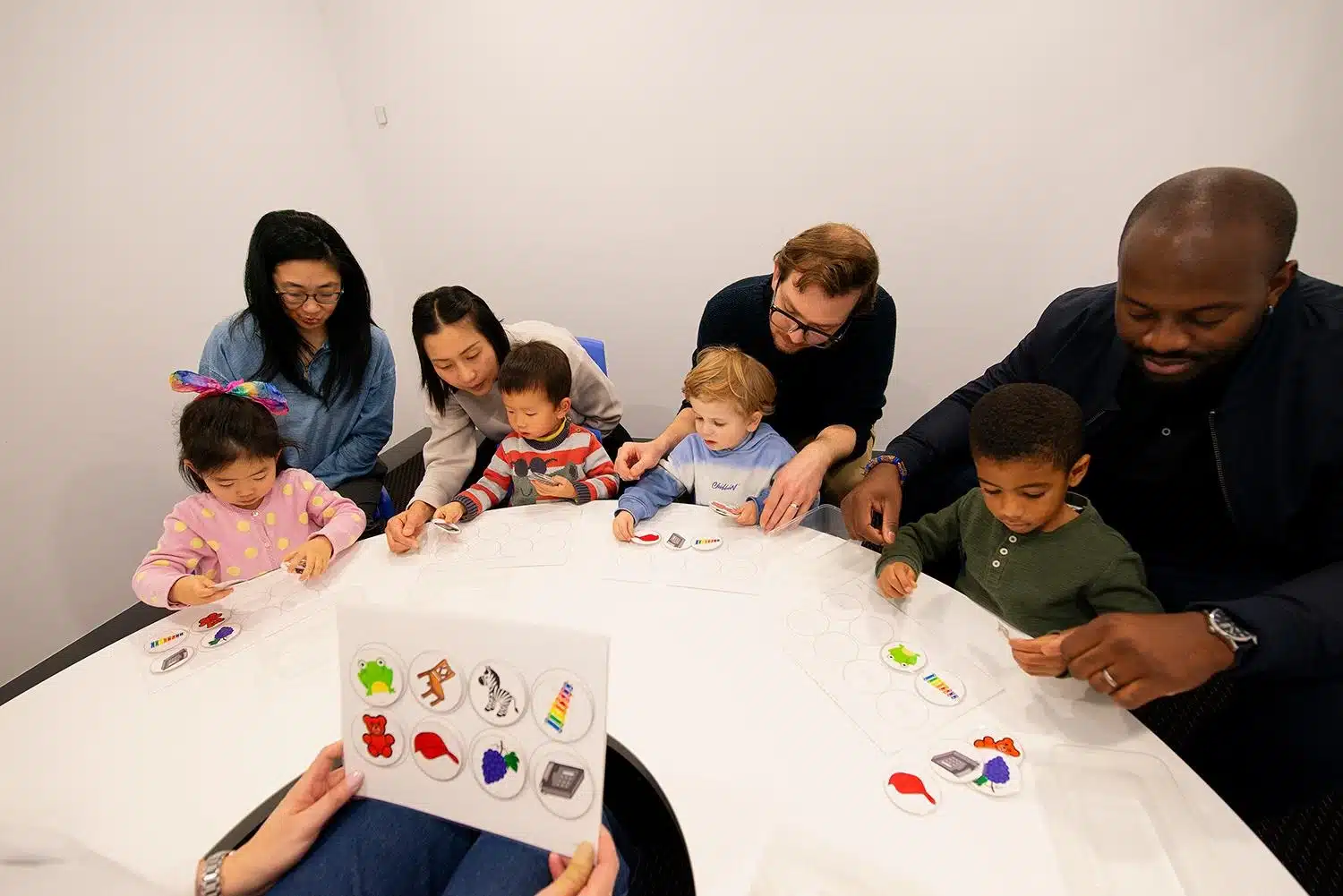 Preschooler and parent playing a memory card game during a Shichida class