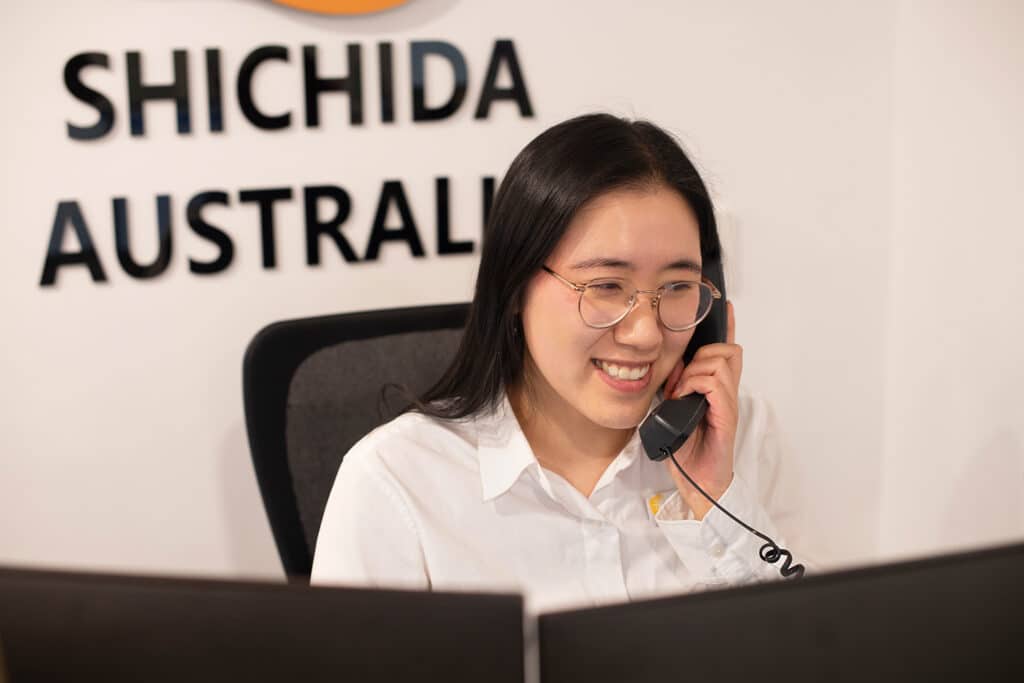 A friendly Shichida staff assisting customer over the phone