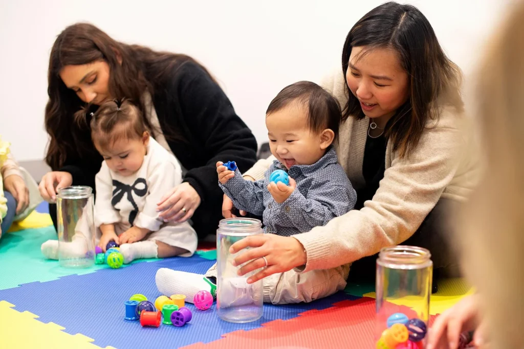 babies-placing-items-narrow-jars